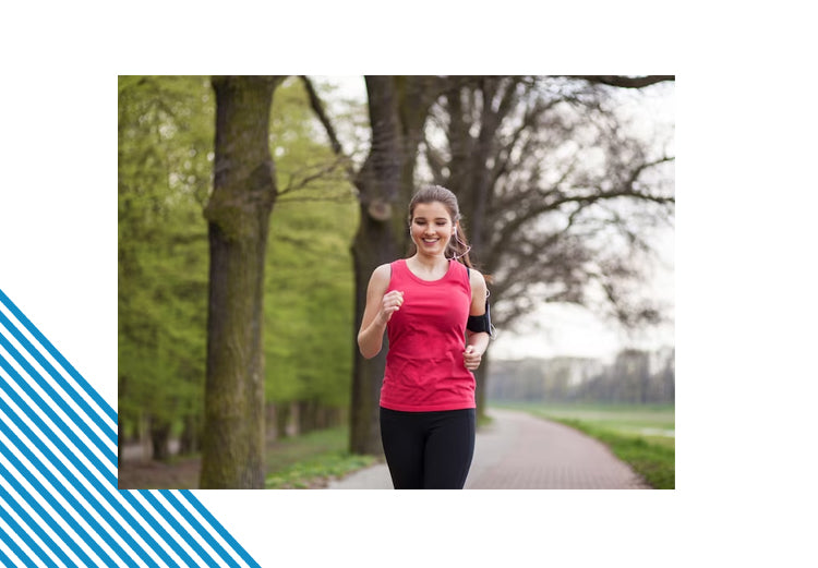 Smiling woman jogging outdoors in a red athletic top; Ashwagandha supports stamina, mood, and balance.