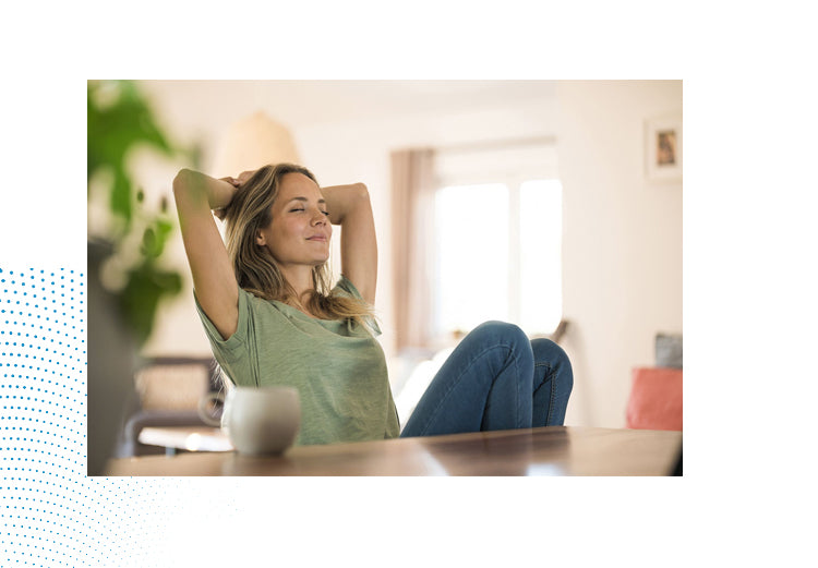 Calm woman leaning back and relaxing at home; magnesium glycinate supports stress relief and relaxation.