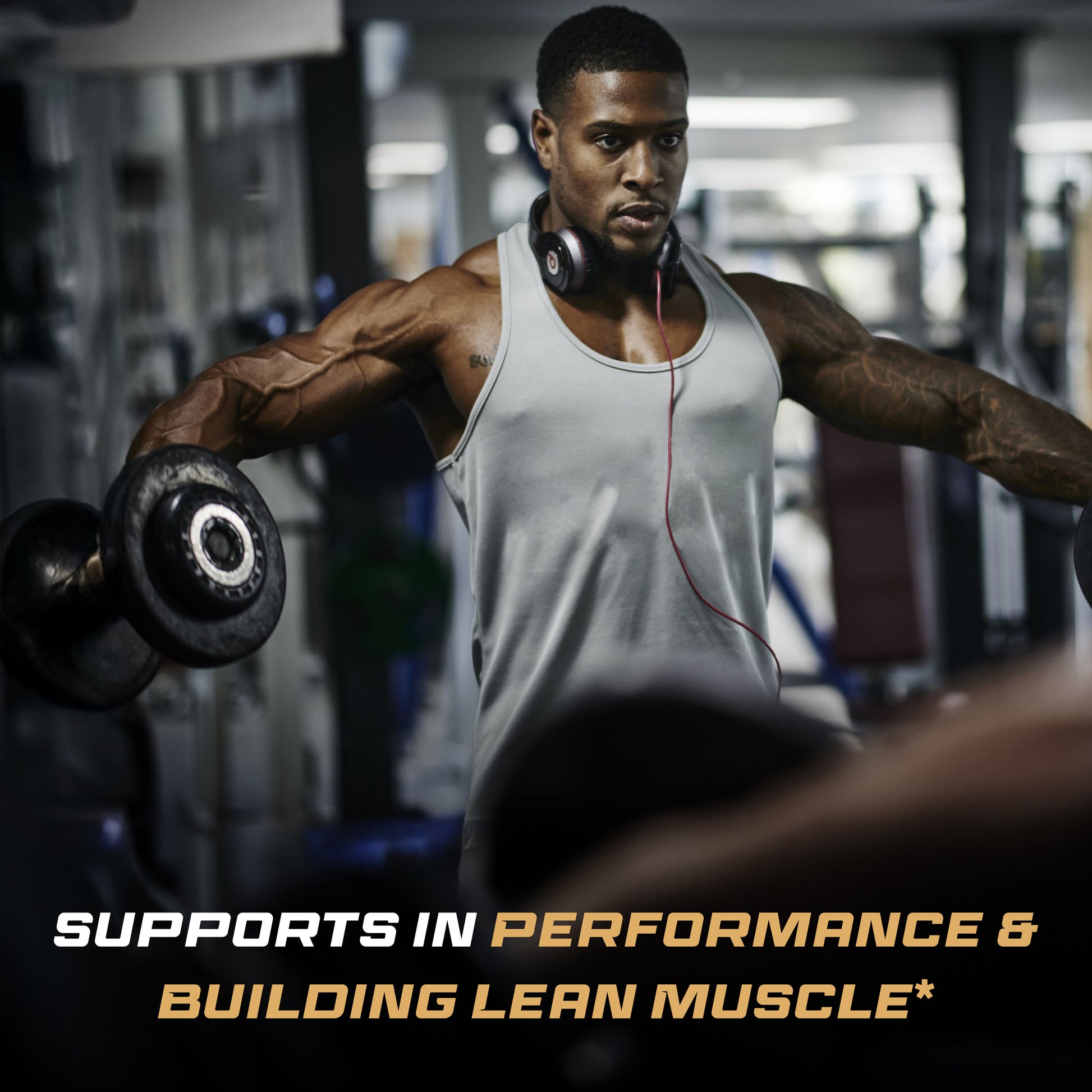 Gym athlete lifts dumbbells during a focused workout session.