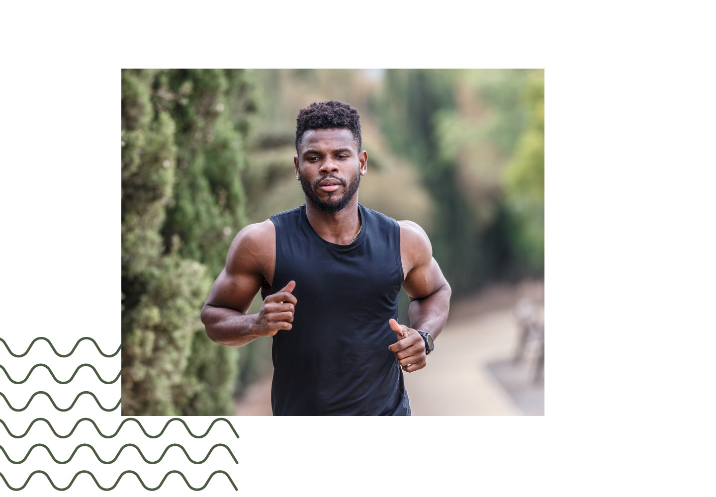 Focused man jogging on a nature trail in athletic wear, symbolizing strength.