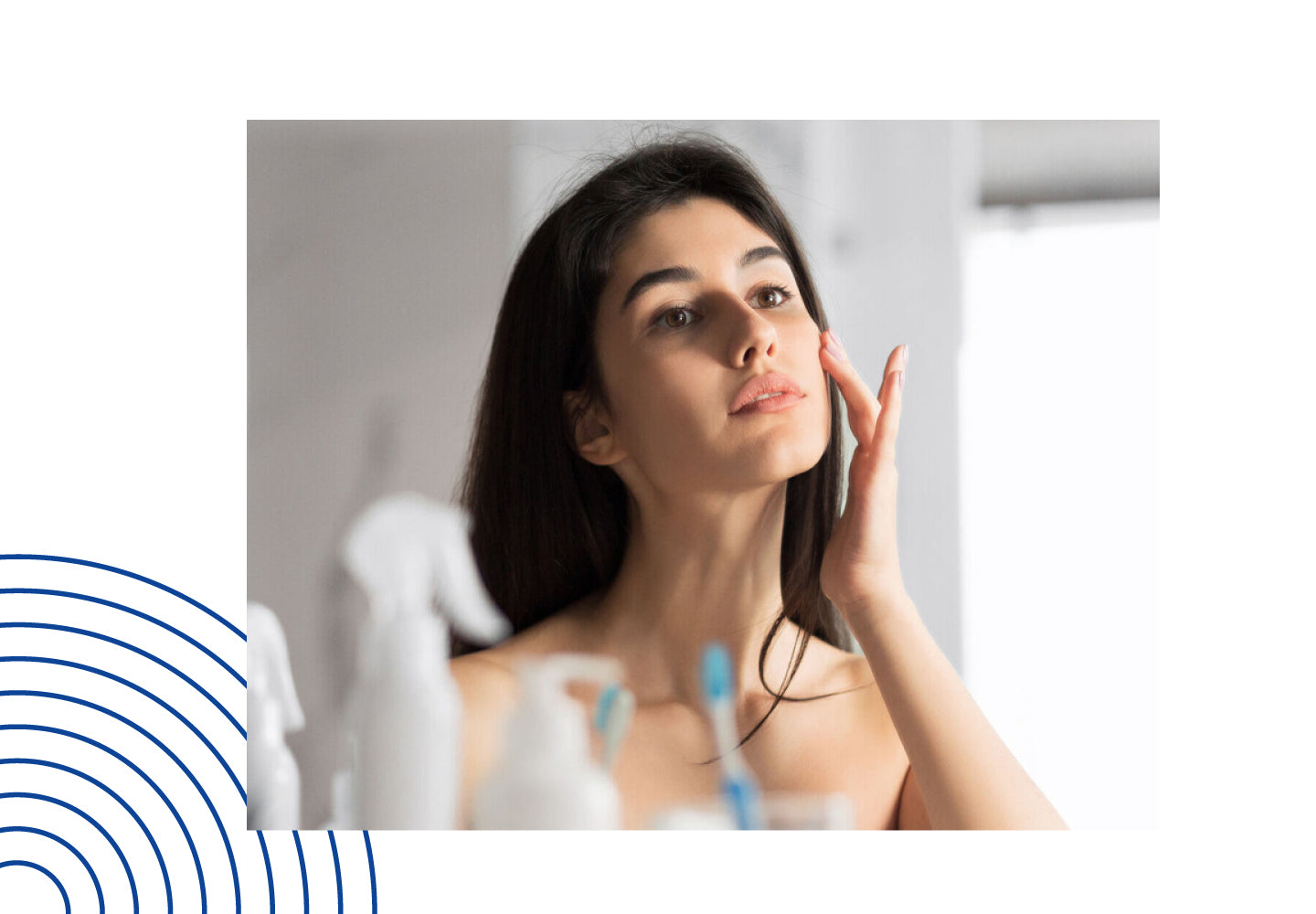 Woman applying oil to her face in front of a bathroom mirror, representing daily skincare with Sandhu’s Organic Castor Oil.