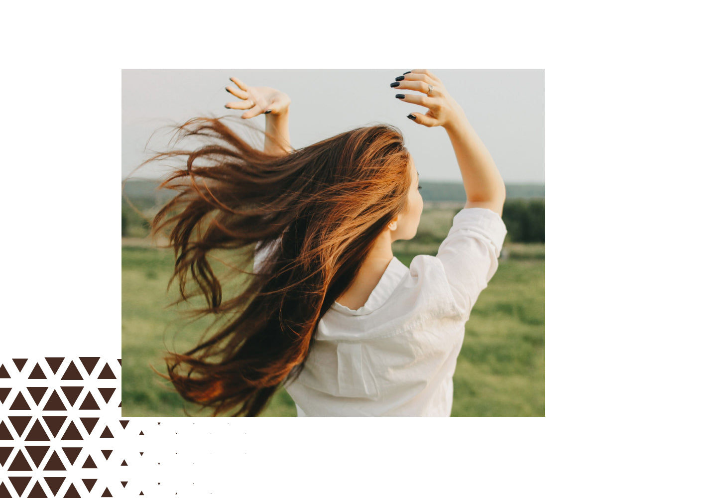 Woman with long shiny hair outdoors, representing hair strength and vitality with Hair Vitamins support.