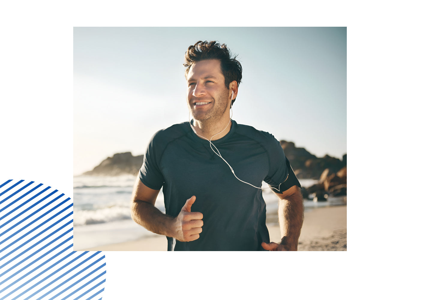 Smiling man jogging on the beach with earphones, representing active lifestyle and wellness support.