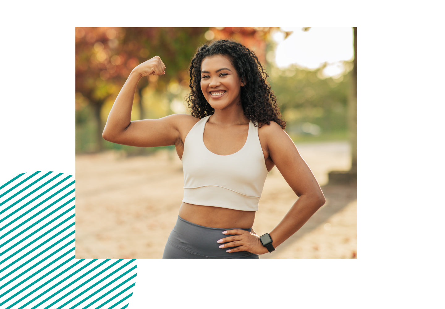 Smiling woman in sportswear flexing arm outdoors, symbolizing strength, confidence, energy, and wellness.