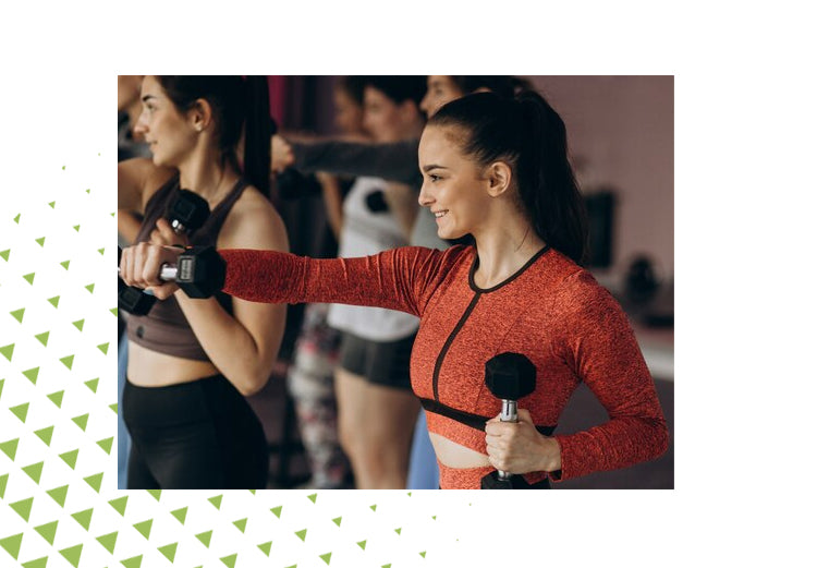 Group of women lifting dumbbells in fitness class, promoting strength, flexibility, and joint health.