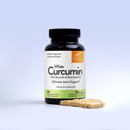 Supplement bottle labeled 'White Curcumin' with capsules on a light gray background