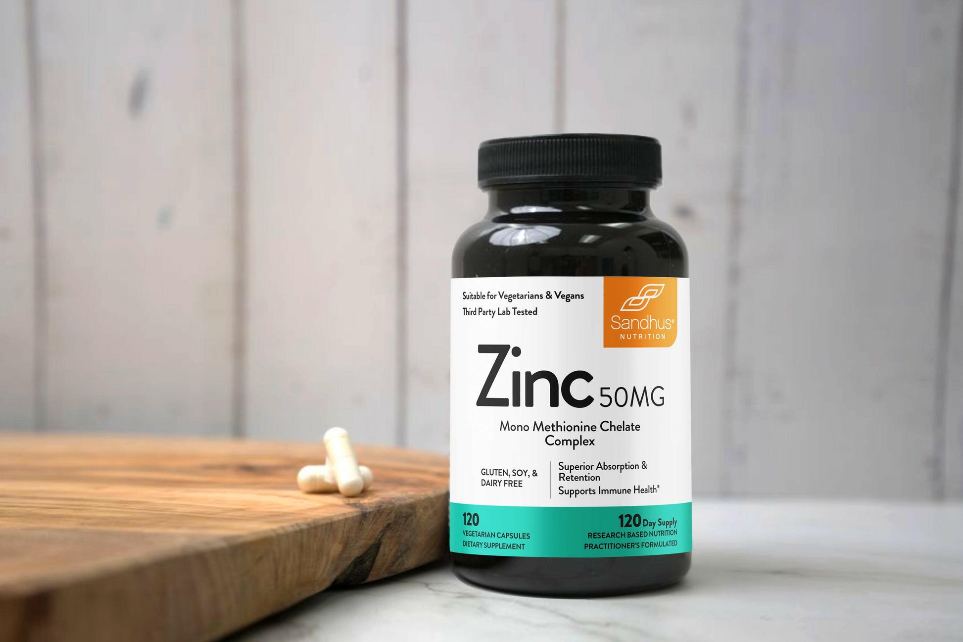 Bottle of Zinc supplement on a wooden surface with a neutral background