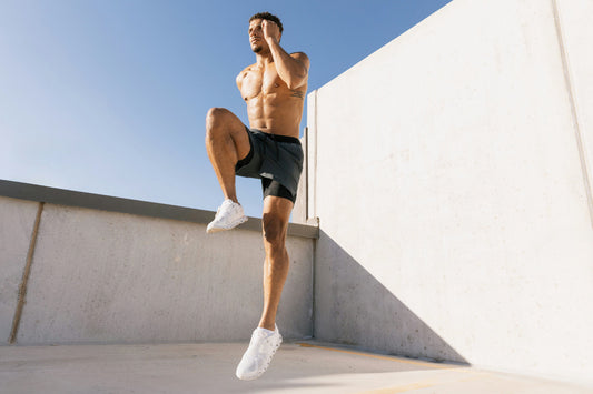 Athletic man performing high-intensity exercise outdoors to support strength, energy, and muscle function