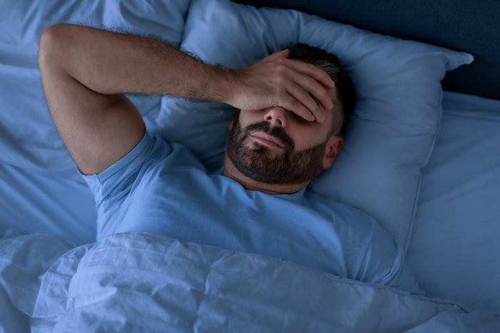 Man experiencing restless sleep and insomnia even after using magnesium supplements.