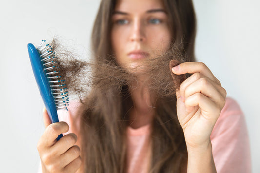Close-up of hair loss in brush showing seasonal shedding problem linked to vitamin D deficiency and weakened hair follicles