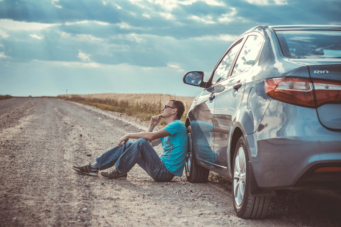 A person taking a quiet break outdoors, reflecting emotional burnout and the need to pause and recharge during the holidays