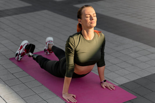 Woman practicing yoga pose to improve flexibility, muscle strength, posture, and joint health during menopause wellness routine