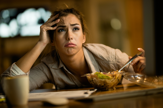 Young woman feeling mentally drained while eating late at night showing mood and emotional changes linked to eating habits