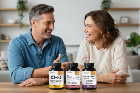 Happy couple discussing fall wellness with Sandhus supplements – Vitamin D3 K2, Zinc Quercetin, and Elderberry capsules on table