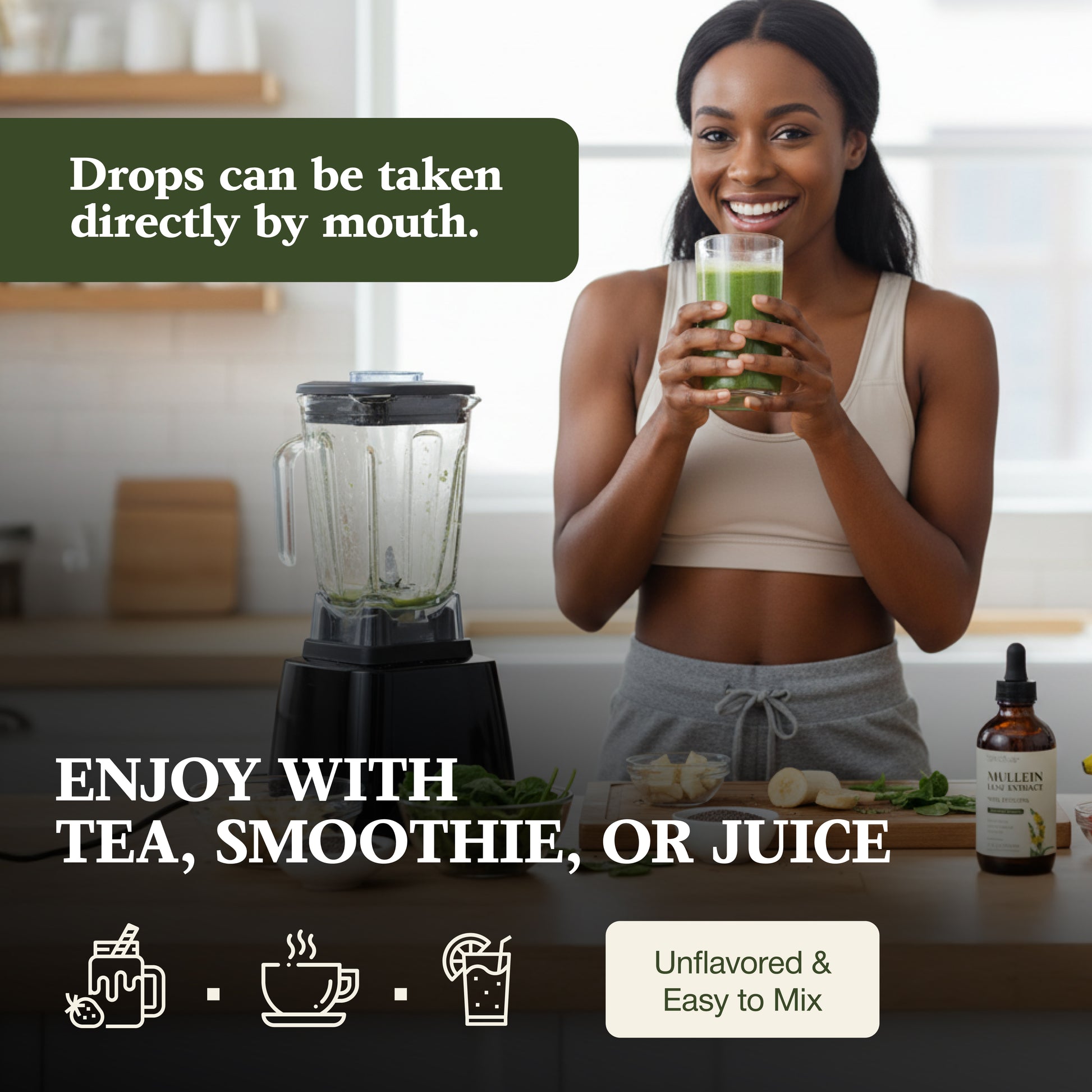 Woman holding a glass of green juice with a blender and bottle in the background.