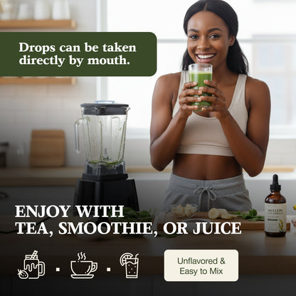 Woman holding a glass of green juice with a blender and bottle in the background.