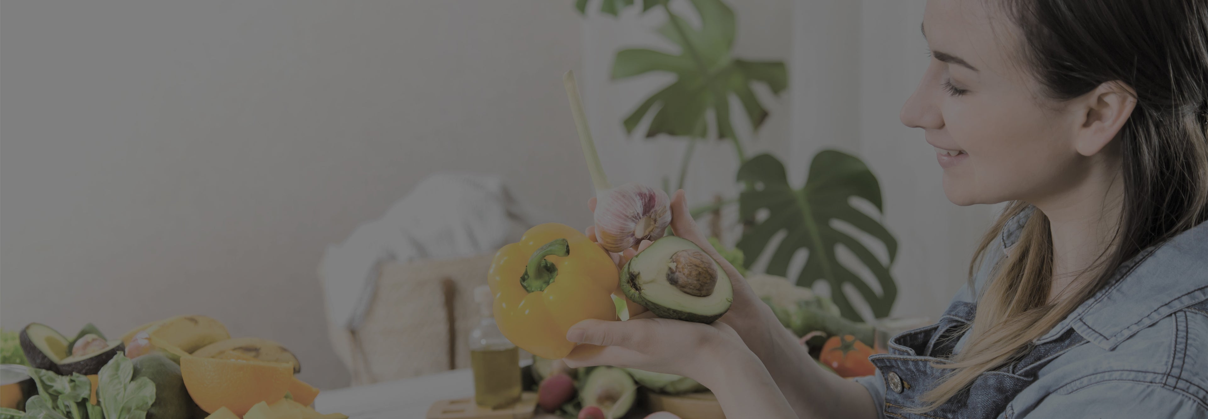 Woman arranging fruit and flowers on a table with a blurred background
