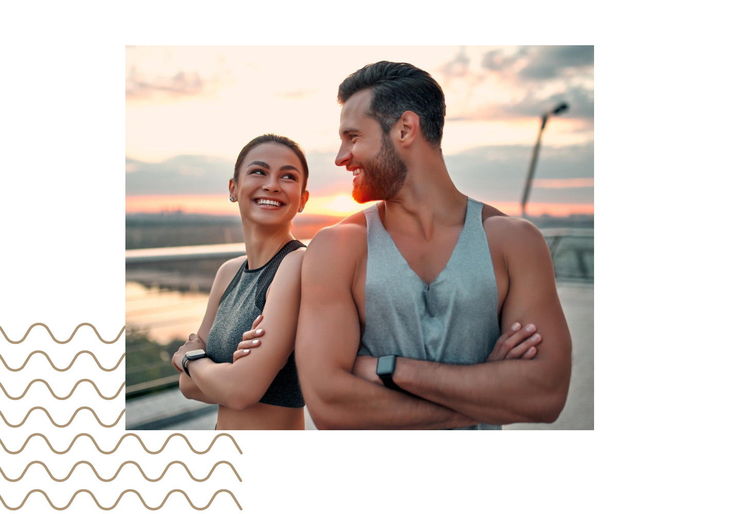 Two people standing together with a scenic background during sunset.