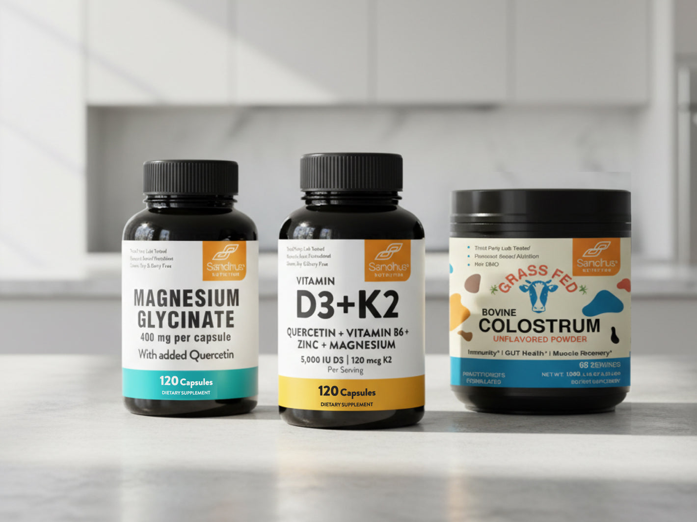 Sandhus Nutrition Magnesium Glycinate, Vitamin D3 K2, and Grass Fed Colostrum supplements displayed on kitchen counter for subscription bundle.
