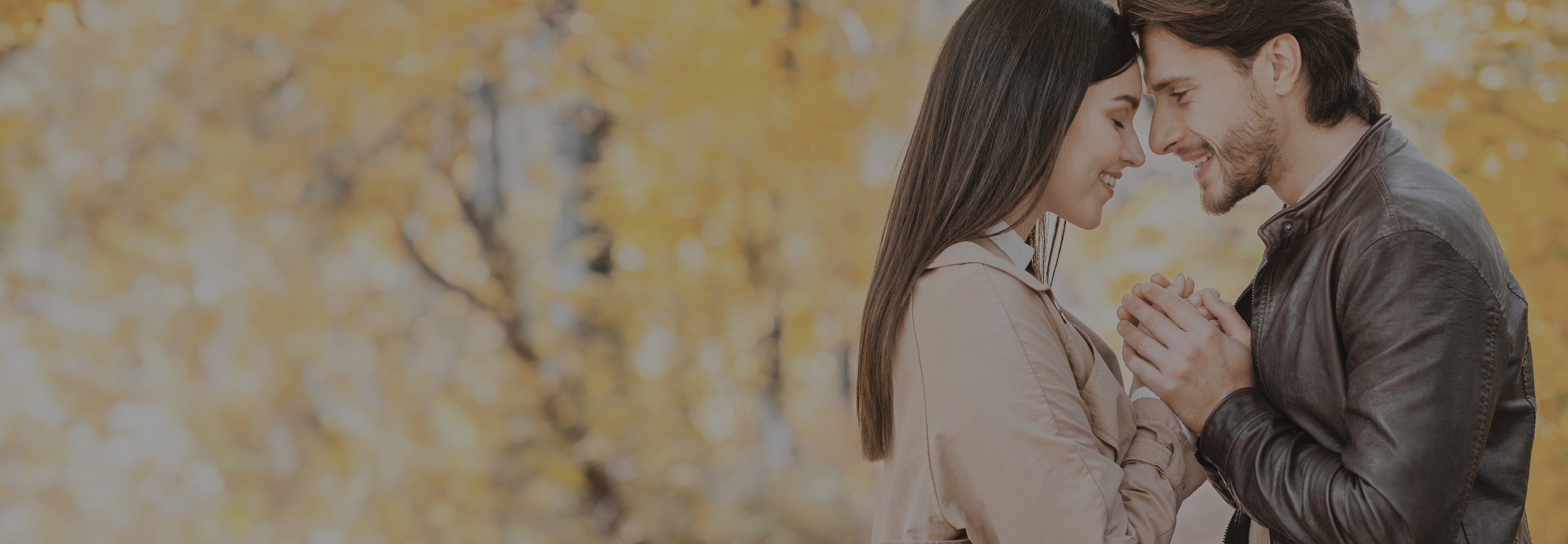 Couple embracing with a blurred yellow floral background