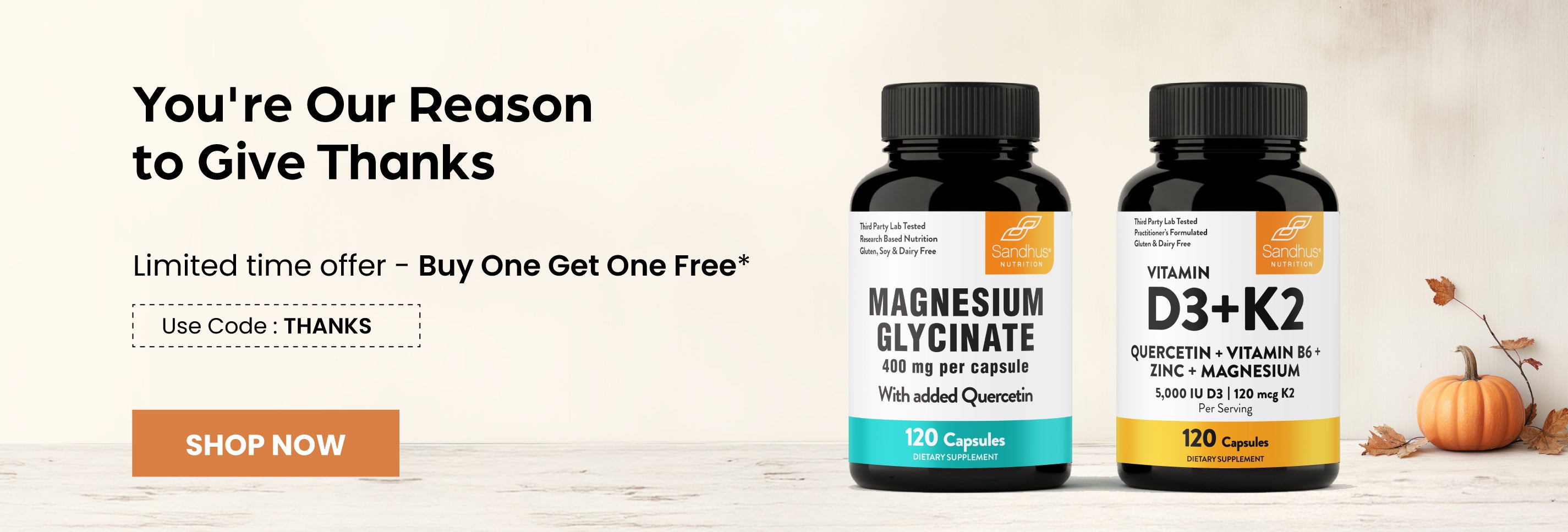 Two supplement bottles with a promotional banner on a wooden surface.